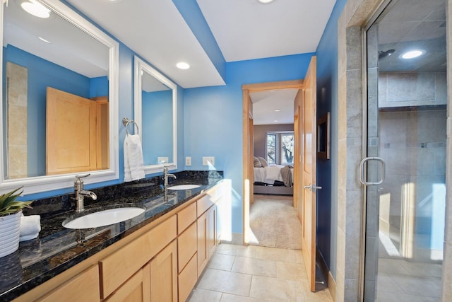 ensuite bathroom with a sink, ensuite bathroom, a shower stall, and double vanity