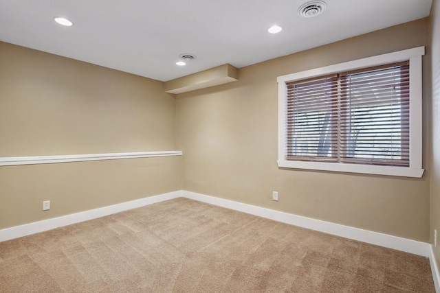 carpeted spare room featuring recessed lighting, visible vents, and baseboards