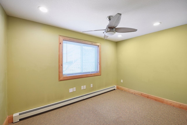 carpeted empty room featuring ceiling fan, recessed lighting, a baseboard heating unit, and baseboards