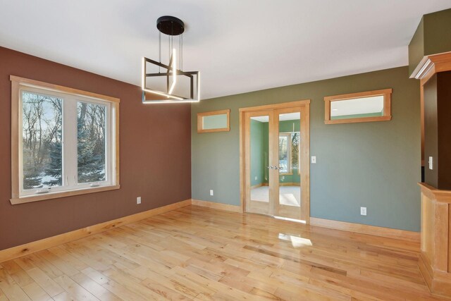 1811 Lake Lucy Ln, Chanhassen, MN 55331 - spare room featuring wood finished floors, baseboards, and french doors