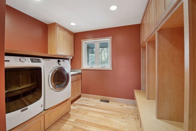 1811 Lake Lucy Ln, Chanhassen, MN 55331 - laundry room featuring separate washer and dryer, light wood-style floors, cabinet space, recessed lighting, and baseboards