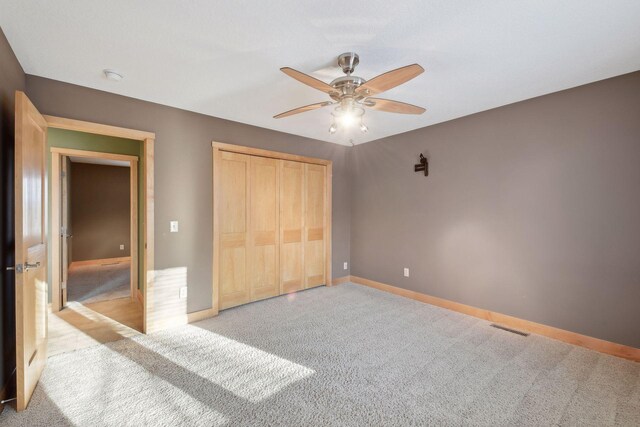 1811 Lake Lucy Ln, Chanhassen, MN 55331 - unfurnished bedroom with carpet floors, baseboards, a closet, and ceiling fan
