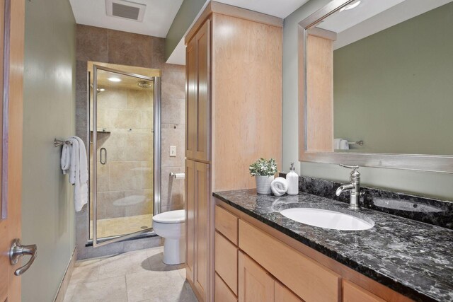 1811 Lake Lucy Ln, Chanhassen, MN 55331 - bathroom featuring toilet, a stall shower, vanity, and tile patterned flooring