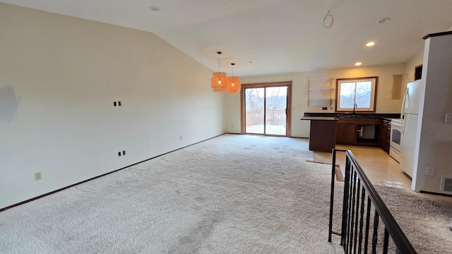 14291 92nd Ave N, Maple Grove, MN 55369 - kitchen with light carpet, a sink, white appliances, open floor plan, and vaulted ceiling