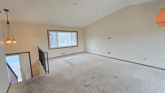 14291 92nd Ave N, Maple Grove, MN 55369 - unfurnished living room with a notable chandelier, carpet, baseboards, vaulted ceiling, and visible vents