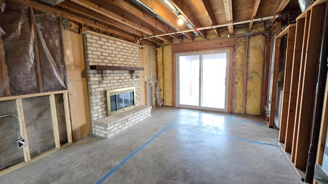 14291 92nd Ave N, Maple Grove, MN 55369 - unfurnished living room featuring a brick fireplace and concrete flooring