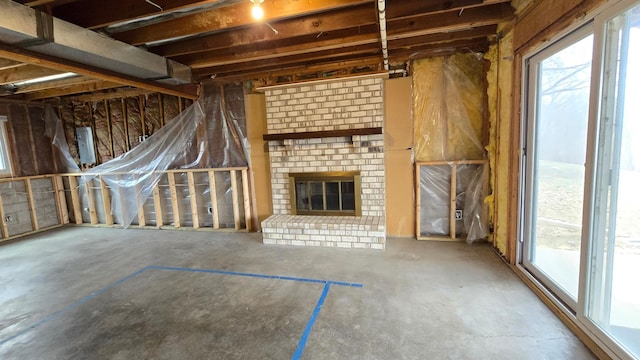 14291 92nd Ave N, Maple Grove, MN 55369 - interior space with unfinished concrete flooring and a fireplace