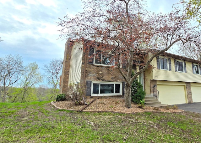 14291 92nd Ave N, Maple Grove, MN 55369 - view of front of home with a chimney, an attached garage, driveway, and brick siding