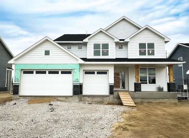 craftsman-style house with covered porch and driveway