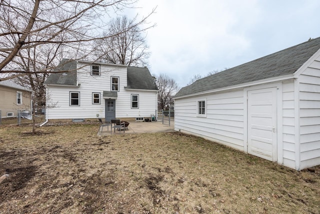 back of property with a patio, fence, and roof with shingles