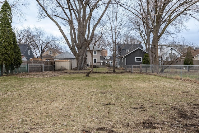 view of yard with a fenced backyard and a residential view