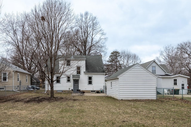 back of property featuring a lawn, fence, an outdoor structure, and roof with shingles