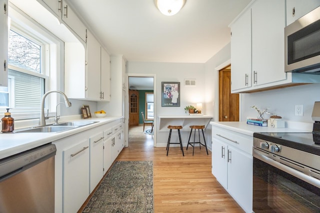 kitchen featuring a sink, visible vents, appliances with stainless steel finishes, and a healthy amount of sunlight