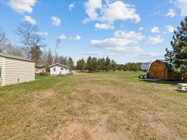 14805 300th St, Red Eye Twp, MN 56477 - view of green lawn with a storage shed and an outbuilding