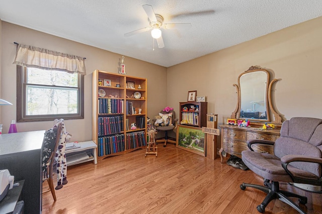 19023 Davis Ave, Faribault, MN 55021 - home office with a textured ceiling, wood finished floors, and a ceiling fan