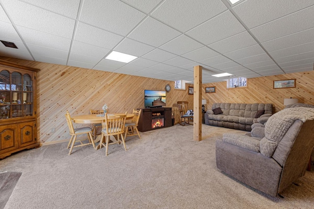 19023 Davis Ave, Faribault, MN 55021 - living area with a paneled ceiling, wooden walls, and carpet floors