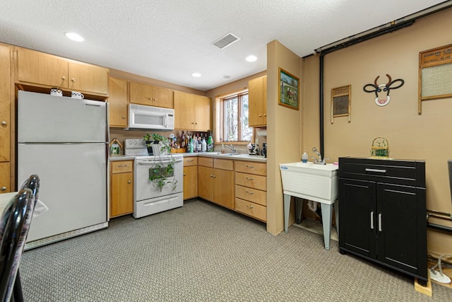 19023 Davis Ave, Faribault, MN 55021 - kitchen with recessed lighting, light countertops, visible vents, and white appliances