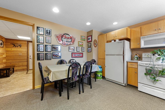 19023 Davis Ave, Faribault, MN 55021 - dining area with light colored carpet, wooden walls, and recessed lighting