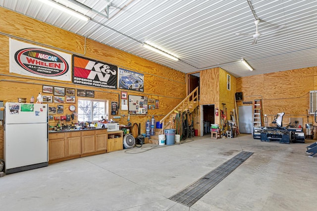 19023 Davis Ave, Faribault, MN 55021 - garage with freestanding refrigerator and wood walls
