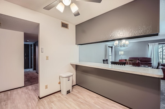 2495 Canabury Dr Unit 220, Little Canada, MN 55117 - bar featuring baseboards, visible vents, ceiling fan with notable chandelier, and light wood-type flooring
