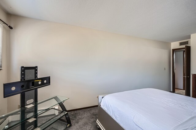 2495 Canabury Dr Unit 220, Little Canada, MN 55117 - bedroom with a textured ceiling, baseboards, visible vents, and dark colored carpet
