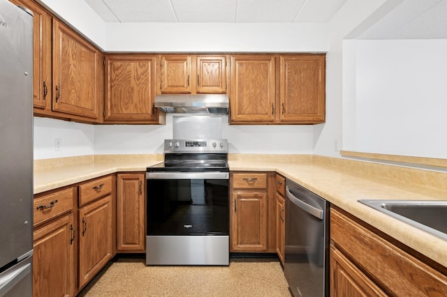 3300 Louisiana Ave S Unit 523, Saint Louis Park, MN 55426 - kitchen featuring ventilation hood, appliances with stainless steel finishes, light countertops, and brown cabinetry