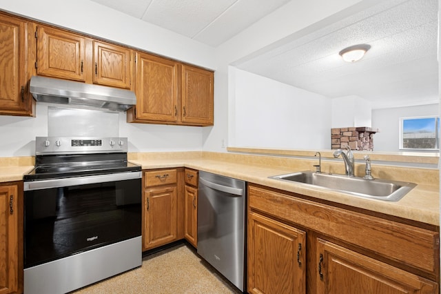 3300 Louisiana Ave S Unit 523, Saint Louis Park, MN 55426 - kitchen featuring stainless steel appliances, under cabinet range hood, light countertops, and brown cabinets