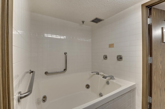 3300 Louisiana Ave S Unit 523, Saint Louis Park, MN 55426 - bathroom featuring a textured ceiling and tile walls