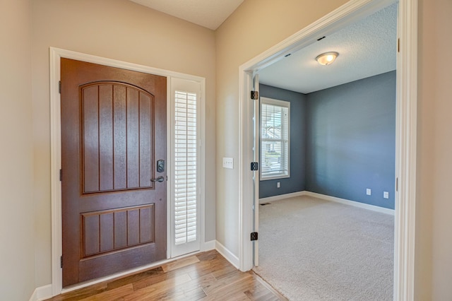 4764 Ashton Curv, Woodbury, MN 55129 - entrance foyer featuring baseboards and wood finished floors