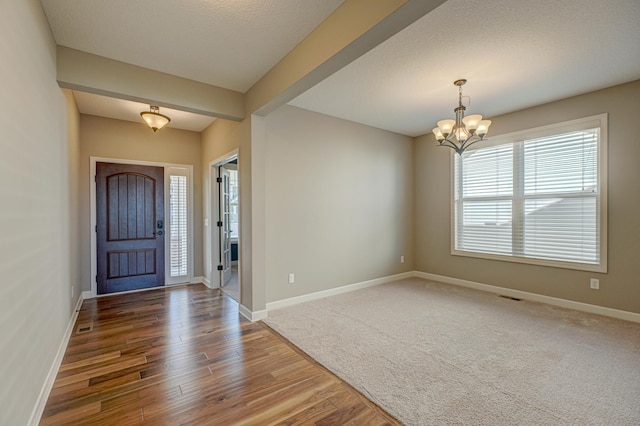 4764 Ashton Curv, Woodbury, MN 55129 - foyer featuring wood finished floors and a chandelier