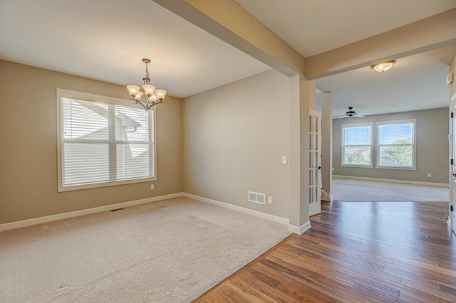 4764 Ashton Curv, Woodbury, MN 55129 - spare room featuring carpet, a chandelier, wood finished floors, and french doors