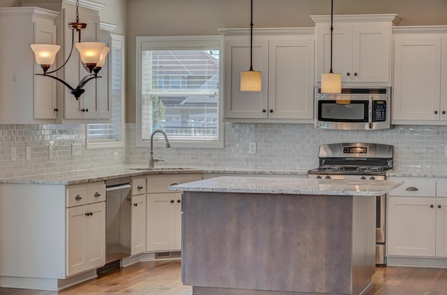 4764 Ashton Curv, Woodbury, MN 55129 - kitchen featuring appliances with stainless steel finishes, light wood-type flooring, and white cabinetry