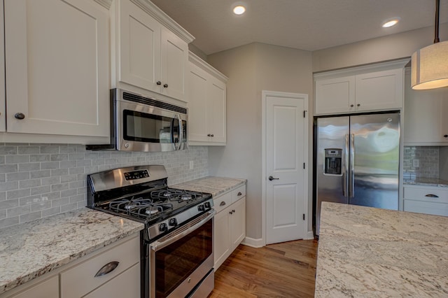 4764 Ashton Curv, Woodbury, MN 55129 - kitchen with appliances with stainless steel finishes, light wood-style flooring, white cabinets, backsplash, and light stone counters