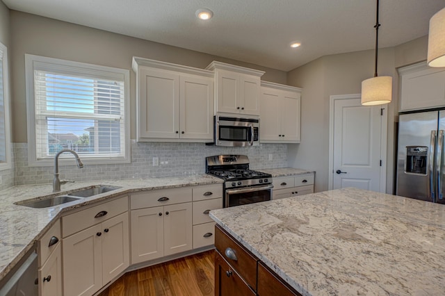 4764 Ashton Curv, Woodbury, MN 55129 - kitchen with appliances with stainless steel finishes, dark wood finished floors, white cabinets, backsplash, and light stone counters