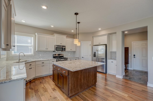 4764 Ashton Curv, Woodbury, MN 55129 - kitchen featuring appliances with stainless steel finishes, light wood-style floors, white cabinetry, recessed lighting, and a textured ceiling