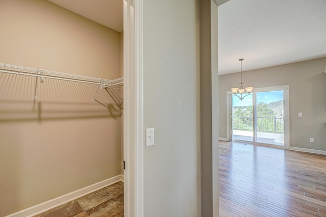 4764 Ashton Curv, Woodbury, MN 55129 - spacious closet with a chandelier and wood finished floors