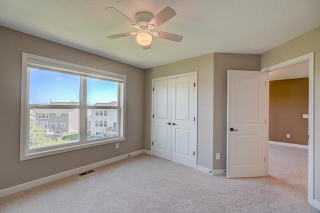 4764 Ashton Curv, Woodbury, MN 55129 - unfurnished bedroom with light carpet, a closet, a textured ceiling, and a ceiling fan