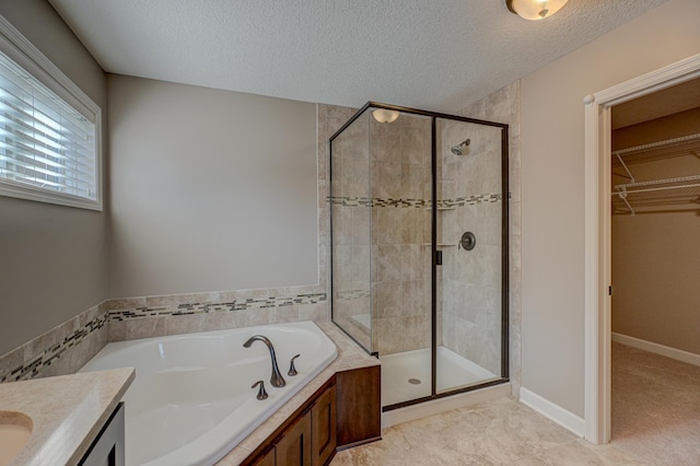 4764 Ashton Curv, Woodbury, MN 55129 - full bathroom featuring a garden tub, a stall shower, a textured ceiling, a walk in closet, and vanity