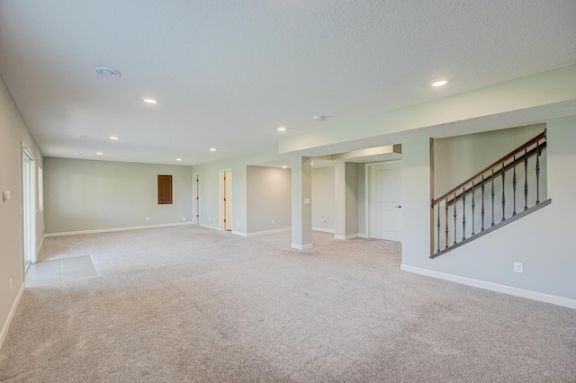 4764 Ashton Curv, Woodbury, MN 55129 - spare room featuring recessed lighting, light colored carpet, stairs, and a textured ceiling