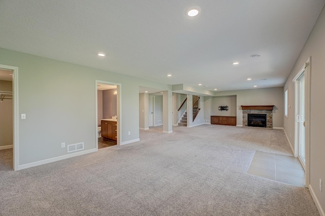 4764 Ashton Curv, Woodbury, MN 55129 - unfurnished living room featuring light colored carpet, a fireplace, stairs, and recessed lighting