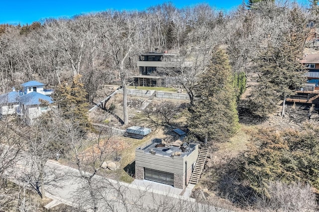 birds eye view of property with a wooded view