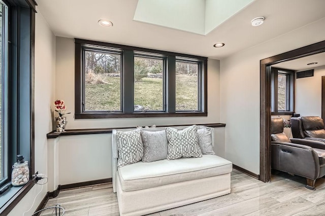 sitting room with a healthy amount of sunlight, light wood finished floors, baseboards, and recessed lighting