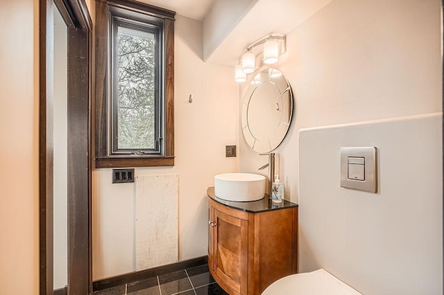 half bath featuring toilet and vanity