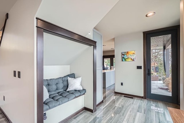 entryway with light wood-style flooring, a healthy amount of sunlight, baseboards, and recessed lighting