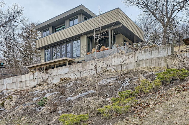 rear view of property featuring fence