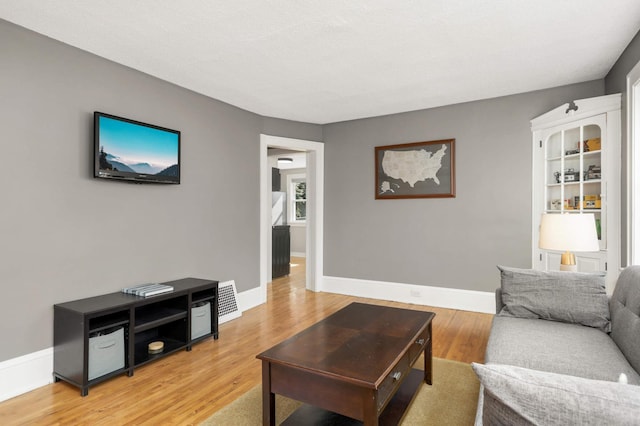 living room with light wood-type flooring and baseboards