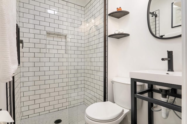 bathroom featuring toilet and a shower stall
