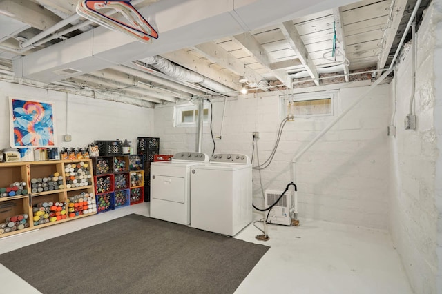 unfinished below grade area featuring washing machine and dryer