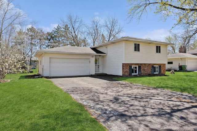 split level home featuring an attached garage, brick siding, driveway, and a front yard