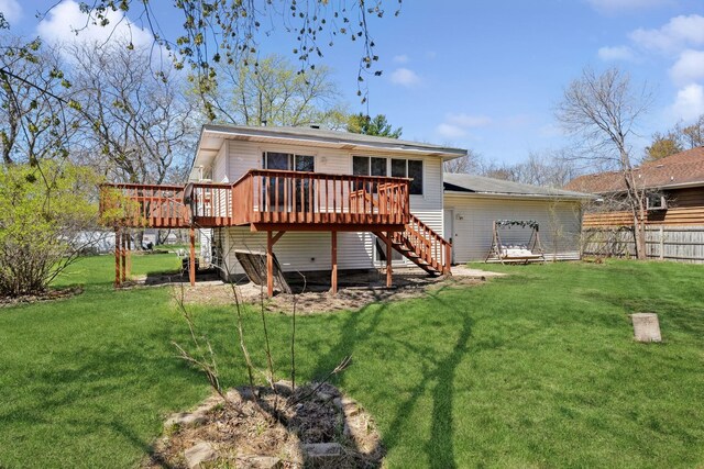 back of property with a wooden deck, fence, stairs, and a yard
